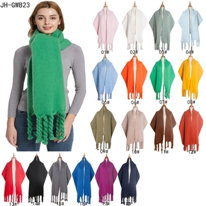 Solid knit shawl with thick tassels in eighteen colors shown on model and matrix