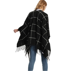 Back view of women's black and white checkered shawl cape with fringe and tassels