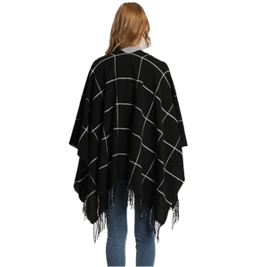 Women's black and white plaid shawl with tassels, back view of the knitted poncho wrap
