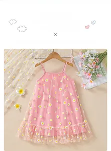 Detail of pink summer girl dress featuring white daisy floral mesh and ruffled hemline