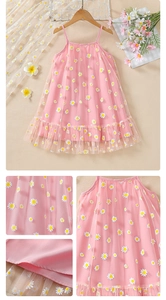 Detail of pink tulle dress featuring delicate white daisy prints and pleated mesh layers