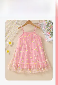 Detail of pink girls tulle dress with daisy floral patterns and ruffle hem on hanger