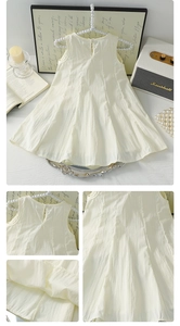 Detail of girls sleeveless cotton summer dress with back button closure and bow accent