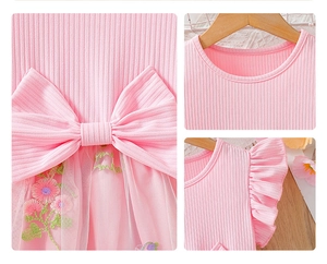 Detail of pink cotton dress with floral mesh embroidery and decorative bow embellishment