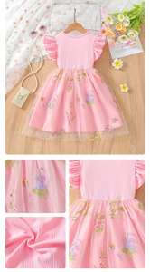 Macro view of floral and butterfly embroidery on pink layered tulle girl's dress