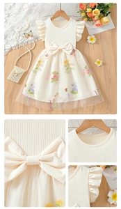 Close-up of girls cream dress featuring floral mesh embroidery and large waist bow detail