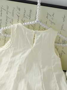 Off-white sleeveless girls' dress with pearl hanger and back button detail