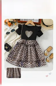 Flat lay of girls' leopard print tutu dress with heart patch and summer accessories