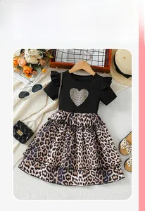 Detail of baby girl short sleeve dress with leopard print skirt and heart pattern