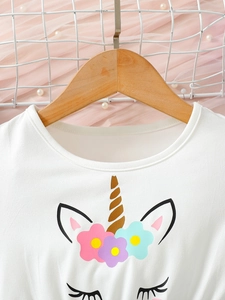 White short-sleeve girls unicorn dress with floral prints on a wooden hanger