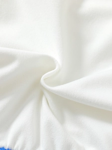 Close-up detail of soft white cotton knitted fabric texture for girls unicorn dress
