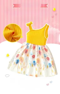 Detail of yellow ribbed cotton bodice with bow and floral mesh skirt for girls