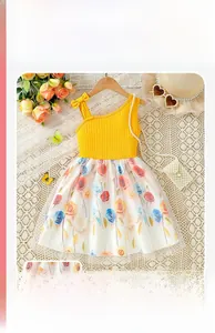 Detailed shot of yellow rib-knit top with pearl chain and floral tulle skirt hem