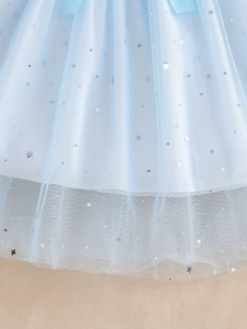 Detailed macro view of light blue mesh fabric with silver star and moon sequins decoration
