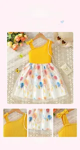 Detail of floral embroidery on double-layered mesh skirt with yellow knit bodice
