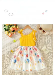 Detail of yellow ribbed cotton bodice with shoulder bows and floral mesh tutu skirt