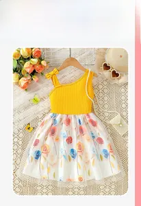 Detail of floral girl dress featuring yellow ribbed bodice and rose print tulle skirt