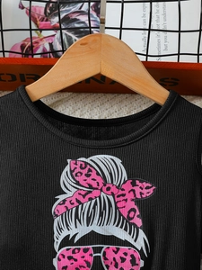 Sleeveless black ribbed knit girl dress with trendy leopard print cartoon graphic