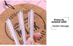 Close-up of three transparent retractable gel pens with white core on a pink background