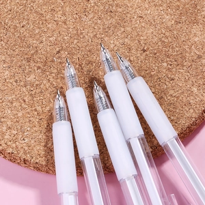 Transparent retractable black gel pens on cork mat with minimalist white frosted barrel