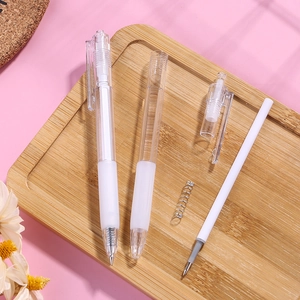 Transparent retractable gel pen with disassembled components on a wooden tray