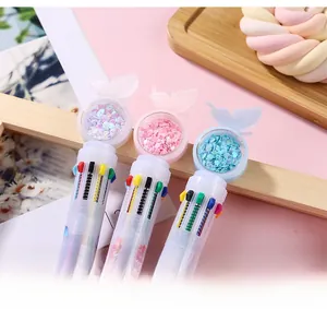 Macro view of multi-color retractable ballpoint pen with butterfly sequin ornament