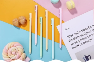 Detailed view of pastel macaron-colored retractable gel pens on vibrant geometric background