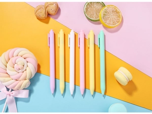 Close-up of six pastel macaron gel pens with matte finish on colorful dessert background