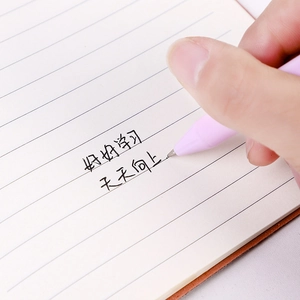 Pink matte retractable gel pen 0.5mm held by a hand writing on a lined notebook