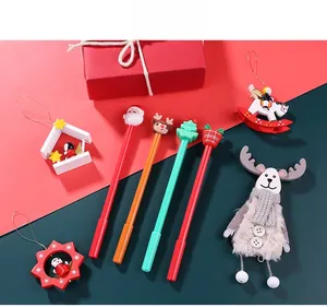Close-up of Christmas gel pens featuring Santa, reindeer, and tree toppers in festive gift set