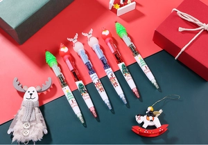Detail of Christmas multi-color ballpoint pens with cartoon Santa and reindeer silicone toppers