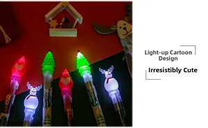 Detail view of colorful LED light-up cartoon Christmas ballpoint pens in dark setting