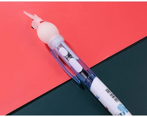 Detail of cartoon Christmas ballpoint pen with multi-color switch and cute rabbit topper