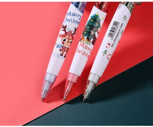 Detailed view of cartoon Christmas ballpoint pens with Santa and reindeer illustrations