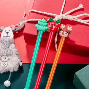 Three Christmas gel pens with Santa, reindeer, and tree toppers in a festive gift set