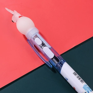 Cartoon Christmas tree ballpoint pen with a white bunny topper on a red and green background