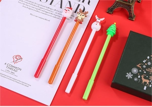 Close-up of Christmas gel pen set with cartoon Santa, reindeer, snowman and tree toppers
