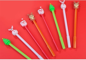 Detail of Christmas gel pens featuring Santa, reindeer, and snowman toppers on red background