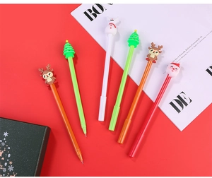 Flat lay view of Christmas Santa and reindeer gel pens on a bright red background