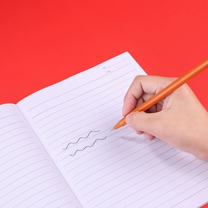 Orange Santa Claus neutral pen writing smooth black lines on a notebook for school