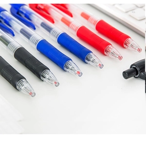 Detail of retractable pens with rubber grips and transparent barrels in three ink colors