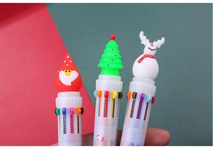 Close-up of 10-color Christmas ballpoint pens with Santa and reindeer cartoon toppers