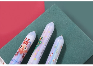 Detailed view of three Christmas multi-color pens with reindeer and tree patterns