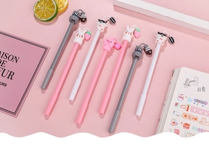 Detailed view of cute animal character pens with silicone toppers on pink background