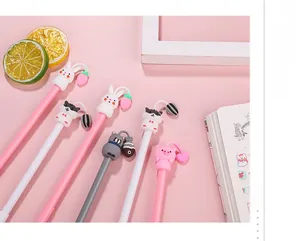 Detail shot of cute animal gel pens with silicone charms like carrots and fish shapes