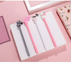 Detailed view of four cute cartoon animal gel pens on a pink decorative display stand