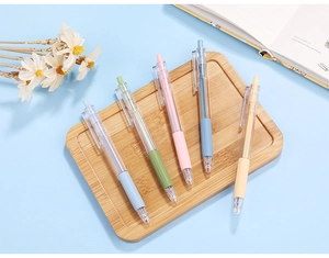 Set of 5 Morandi colored retractable gel pens with soft grips on a bamboo tray