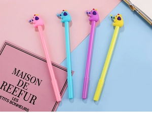 Detail view of four colorful elephant-topped gel pens in pink, blue, purple, and yellow