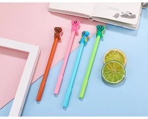 Detailed close-up of four colorful cartoon dinosaur gel pens on a pastel stationery background