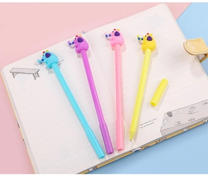 Close-up of four colorful cartoon elephant pens arranged on an open notebook